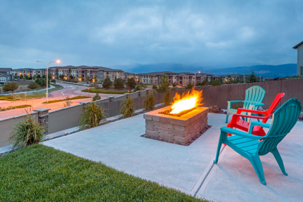 a fire pit with three chairs