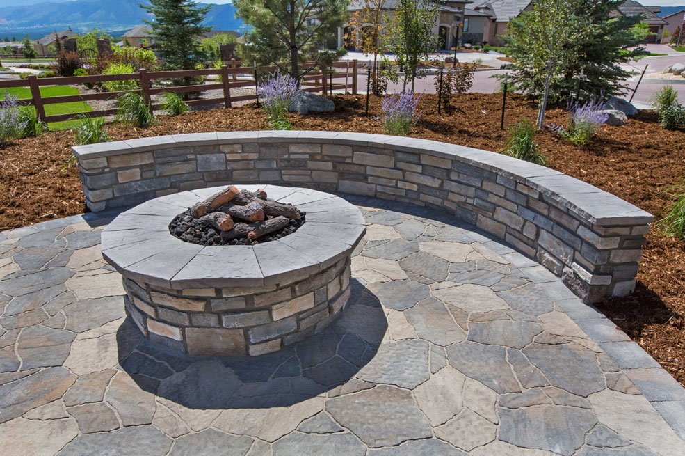 a fire pit with a stone wall around it